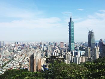 View of skyscrapers against cloudy sky