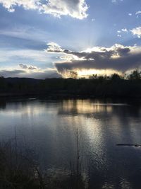 Scenic view of lake against sky at sunset