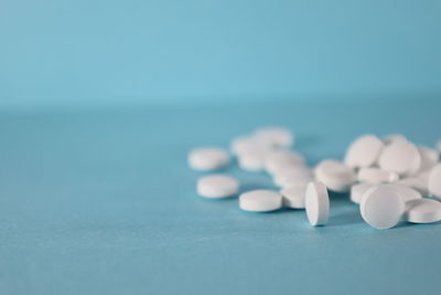 Close-up of pills on blue table