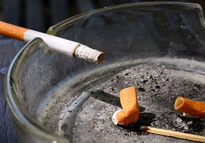 Close-up of burning cigarette in ashtray