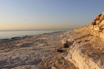 Scenic view of sea against clear sky at sunset