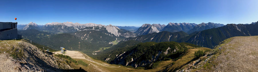 Panoramic view of mountains against clear blue sky