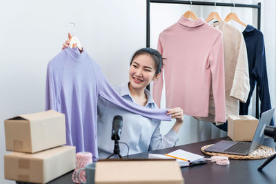 Portrait of smiling woman using laptop on table
