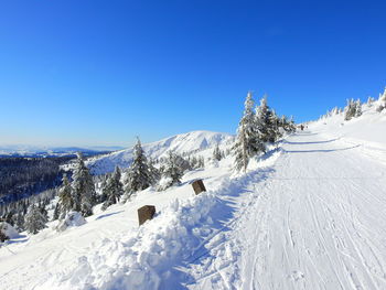 Scenic view of snowcapped mountains against clear blue sky