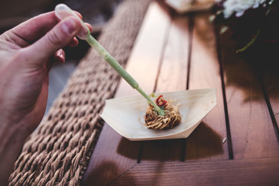 Cropped hand of woman making food