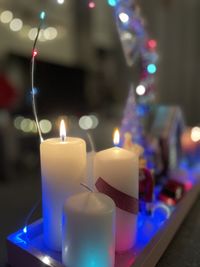 Close-up of illuminated candles on table