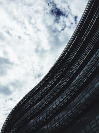 Low angle view of skyscraper against cloudy sky