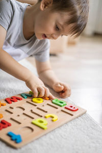 Boy playing with toy blocks on table