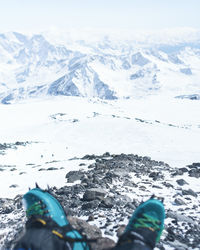 Low section of person on snowcapped mountain