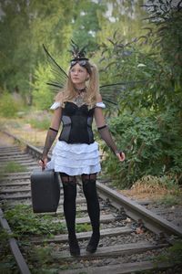 Full length of woman walking on railroad track