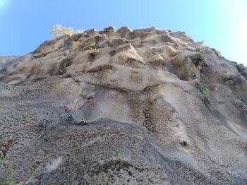 Low angle view of rock formation in desert against sky