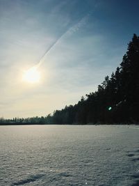 Scenic view of frozen lake against sky during sunset