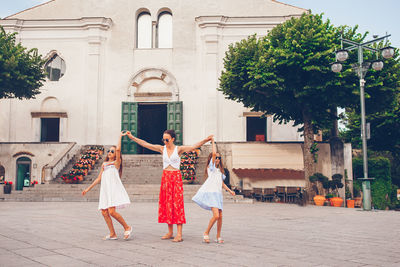 Group of people walking by building