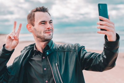 Portrait of young man photographing