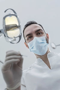 Close-up of doctor wearing surgical mask