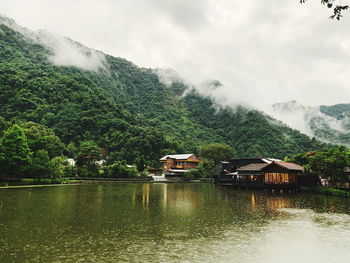 Scenic view of lake and mountains against sky