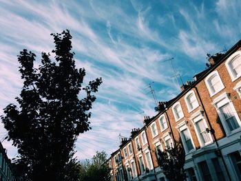 Low angle view of building against cloudy sky