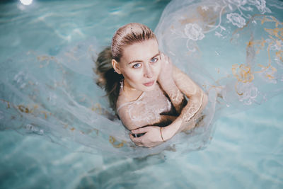 Portrait of young woman in swimming pool