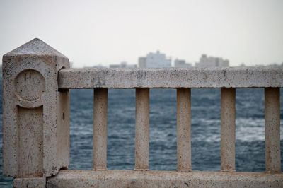 Bridge over sea against clear sky