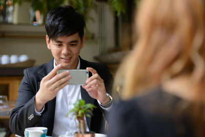 Young man using mobile phone outdoors