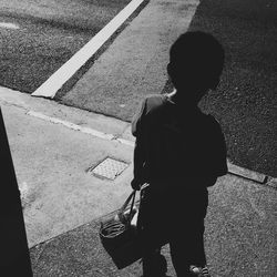 High angle view of woman standing on road