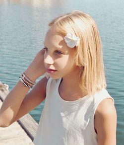 Portrait of young woman with eyes closed by lake