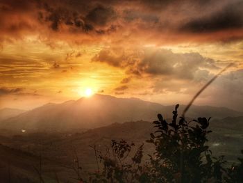 Scenic view of silhouette mountains against sky at sunset