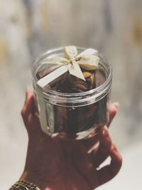Close-up of hand holding glass jar