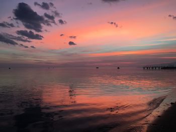 Scenic view of sea against romantic sky at sunset