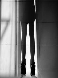 Low section of woman standing on tiled floor