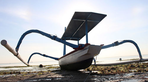 Airplane on beach against sky