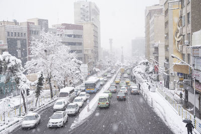 Panoramic view of city street and buildings during winter