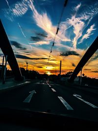 Cars on road at sunset