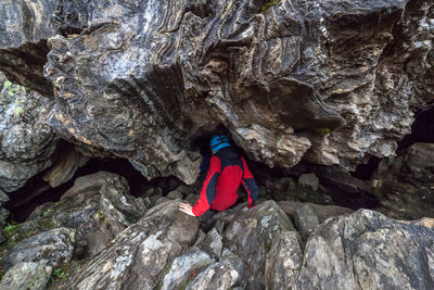 Rear view of person amidst rock formations at jotunheimen national park