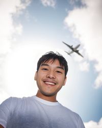 Portrait of young man against sky