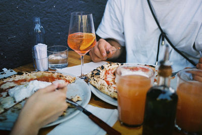 Midsection of people having food on table