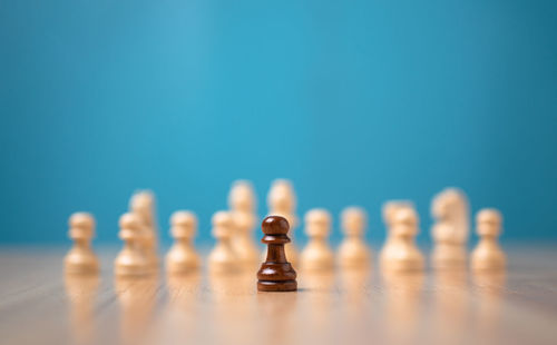 Close-up of chess pieces against blue background