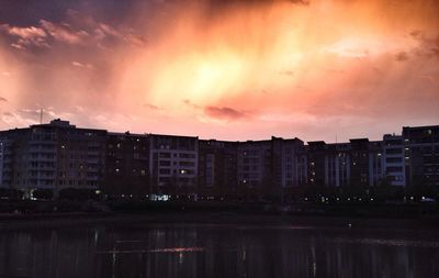 Buildings in city at sunset