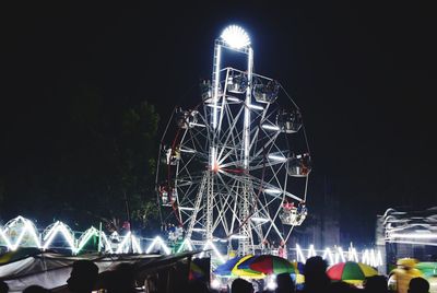 Illuminated ferris wheel at night