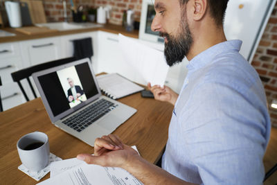 Businessman on video call through laptop at home