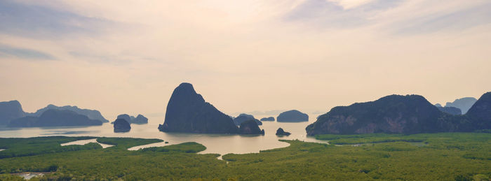 Scenic view of sea and mountains against sky