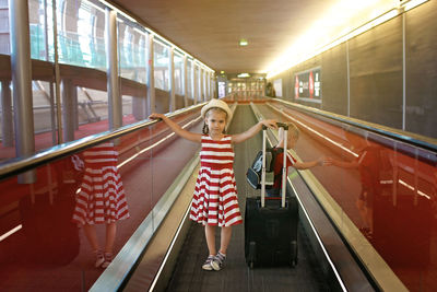 Girl standing on escalator