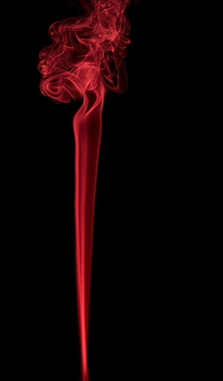 CLOSE-UP OF RED BURNING AGAINST BLACK BACKGROUND