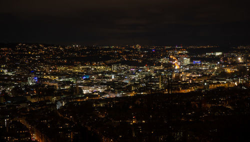 High angle view of illuminated city against sky at night