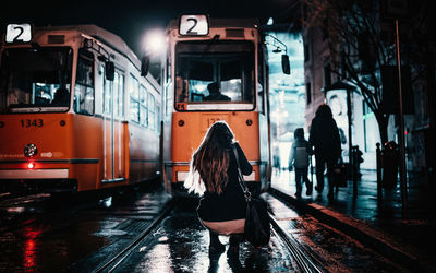 Rear view of woman in bus at night