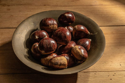 High angle view of chestnuts in bowl on table