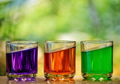 Close-up of multi colored drinks in glass