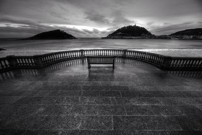 Observation point by sea against sky at dusk