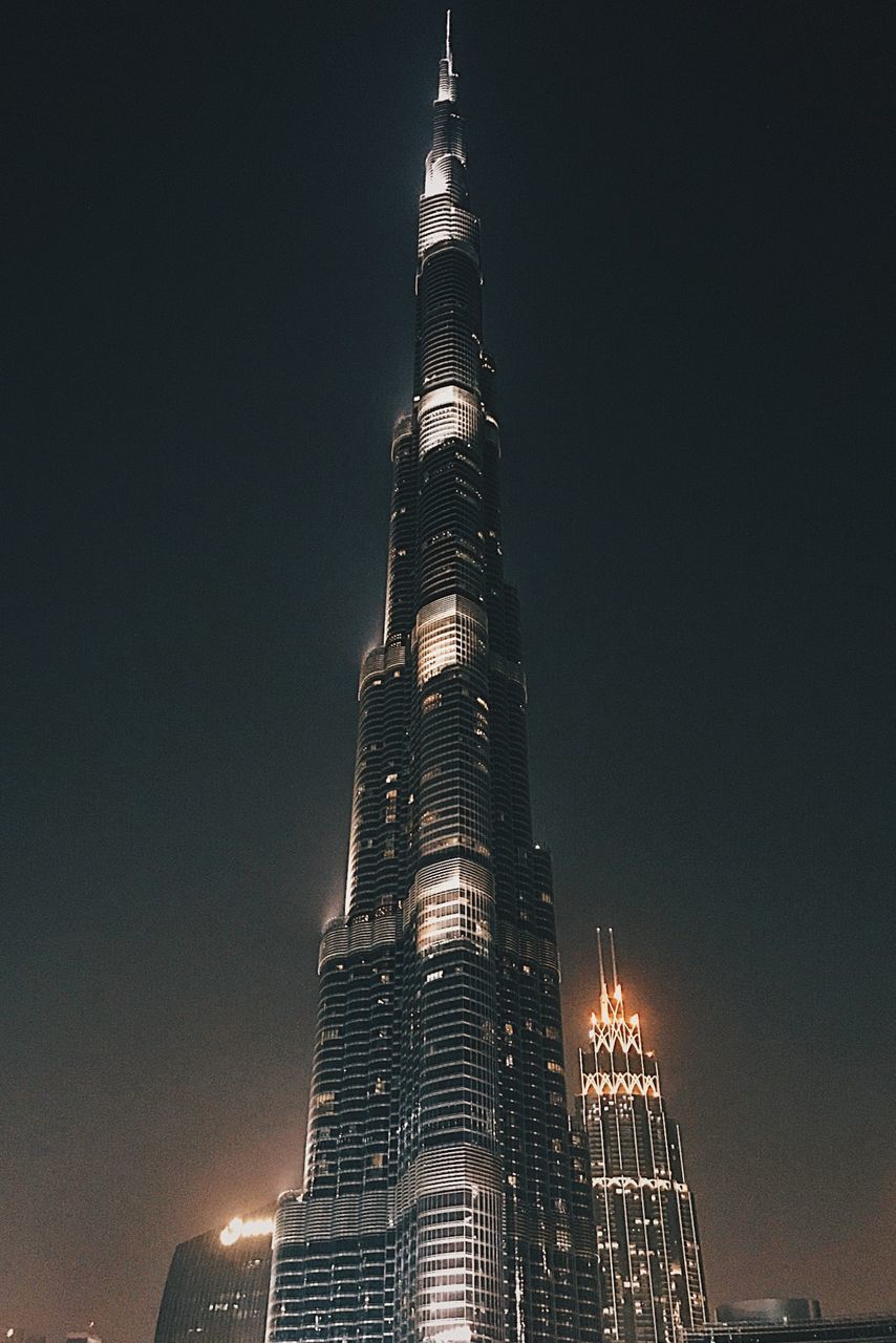 architecture, building exterior, built structure, tall - high, illuminated, tower, skyscraper, sky, night, office building exterior, building, low angle view, travel destinations, city, no people, tourism, office, nature, modern, outdoors, spire, financial district
