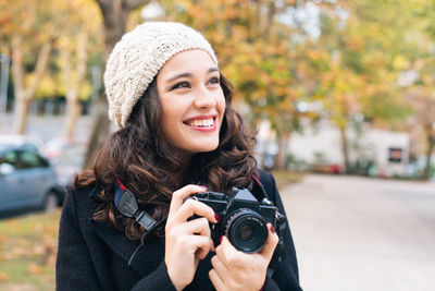 Portrait of happy woman photographing